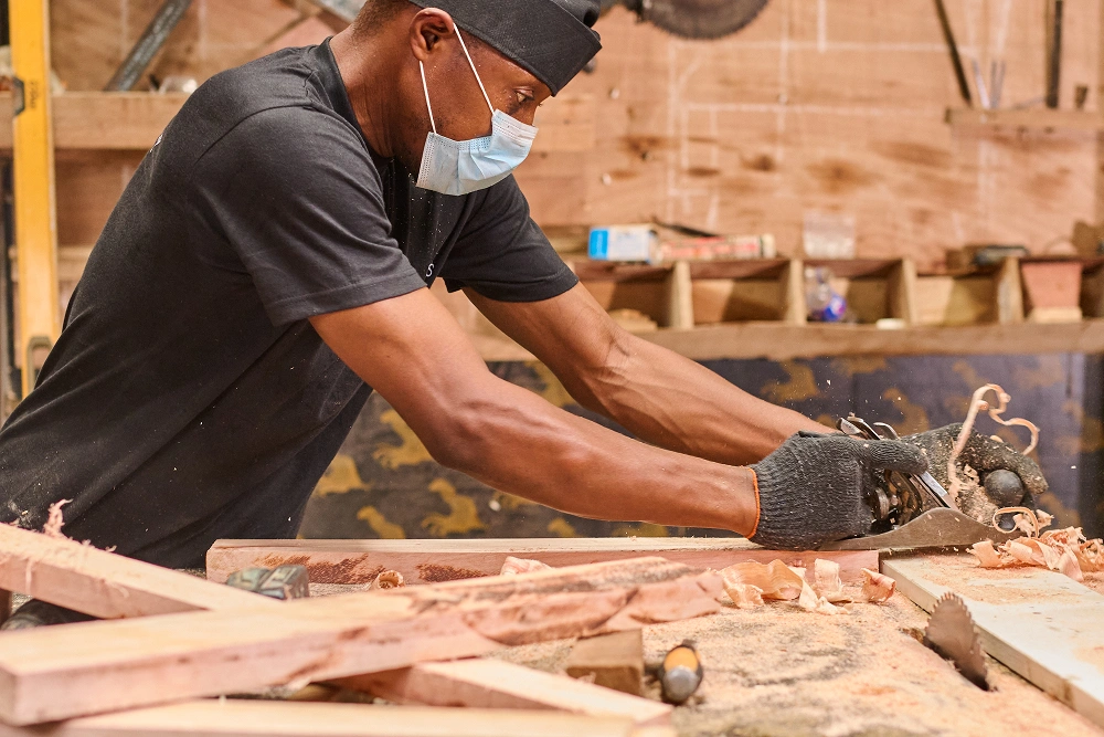 Majeurs holdings furniture workman working on a wood piece - Furniture Manufacturer